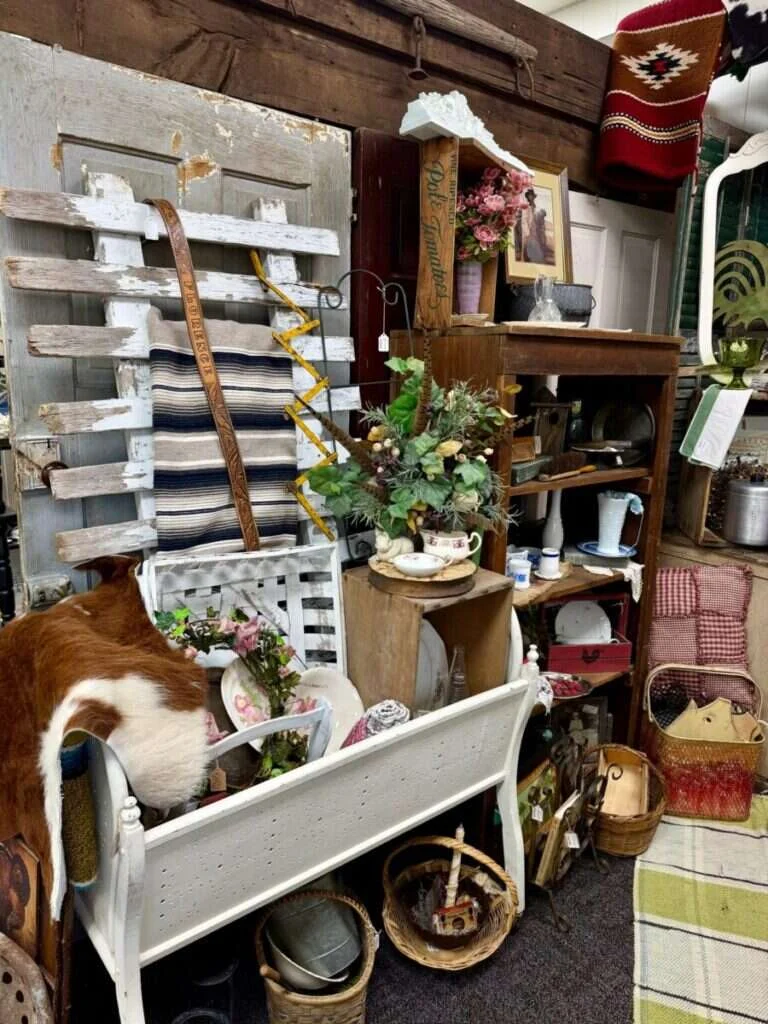 Booth 65 at Twisted Sisters Vintage Market, filled with primitive salvage, weathered shutters and rustic farmhouse decor