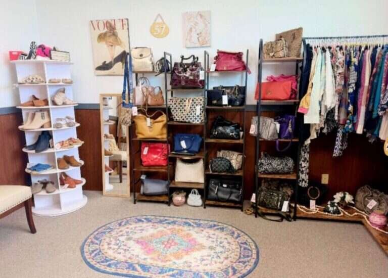 Booth 57 at Twisted Sisters Vintage Market, a boutique display of handbags, shoes, scarves and clothing